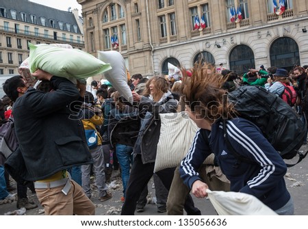 PARIS - APRIL 6: Unidentified people participate in pillow fight at Gare Saint-Lazare square on April 6, 2013 in Paris, France. This year the International Pillow Fight Day was celebrated  on April 6.