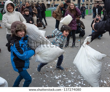 PARIS - APRIL 6: Unidentified boys take part in pillow fight on April 6, 2013 in Paris, France. This year the International Pillow Fight Day was celebrated  on April 6 at Gare Saint-Lazare square .
