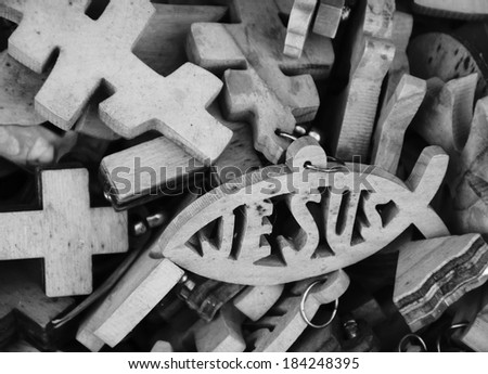 Different wooden crosses and Jesus fish symbol for sale at market in Old City of Jerusalem (Israel). Black and white.