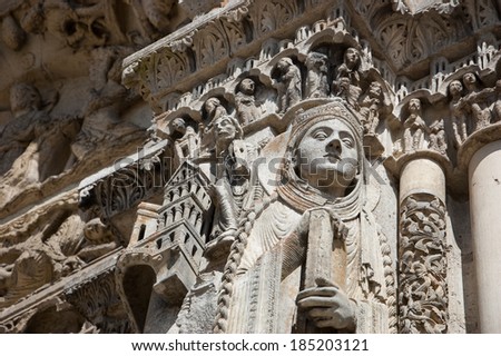 Figure of saint holding the book. Royal portal of Chartres cathedral. Chartres, France.