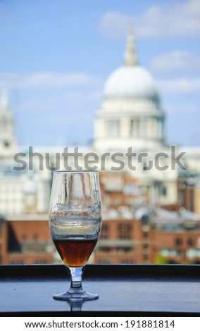A glass of beer and a view from Tate Modern gallery\'s cafe on St Paul Cathedral. London, England.