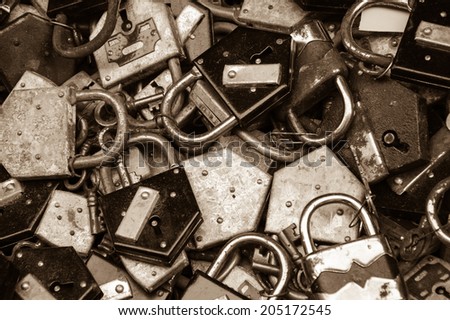 Old rusty locks and keys at flea market in Paris. Aged photo. Sepia.