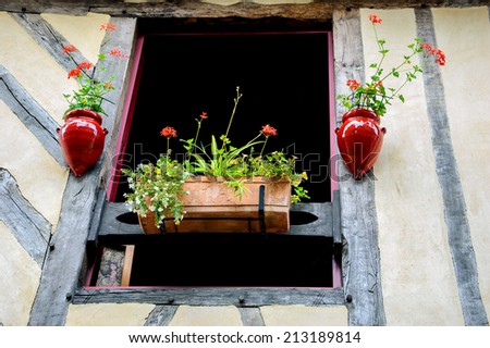 Old half timbered house house decorated with flowers.  Dol de Bretagne, Brittany, France.
