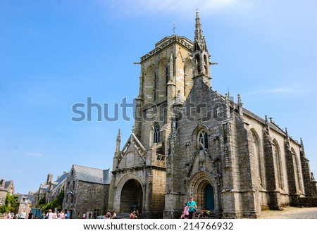 LOCRONAN, FRANCE - JULY 23, 2014: Tourist visit Saint Ronan church in medieval village Locronan. This village is included in list of \