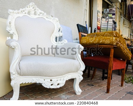 BEERSHEBA, ISRAEL - FEBRUARY 16, 2014: Old ornate armchair and upholstery samples near the entry to the workshop in Old City. The construction Beersheba's Old City began in 1900 during Ottoman era.