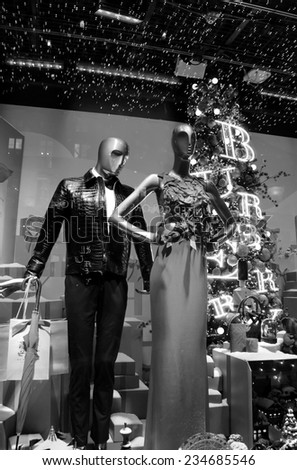 PARIS, FRANCE - NOVEMBER 22, 2014: Colorful Christmas decoration by Burberry in the windows of Printemps department store attracts Parisian children and tourists.
