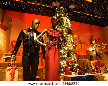 PARIS, FRANCE - NOVEMBER 22, 2014: Colorful Christmas decoration by Burberry in the windows of Printemps department store attracts Parisian children and tourists.
