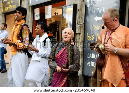 PARIS, FRANCE - OCTOBER 4, 2014: Unidentified members of Hare Krishna play music and sing on boulevard Saint-Michel in Latin Quarter.