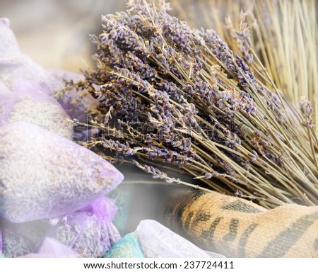 Dried lavender for sale in transparent  bags. Selective focus on dried flowers bunch over the rough  bag.