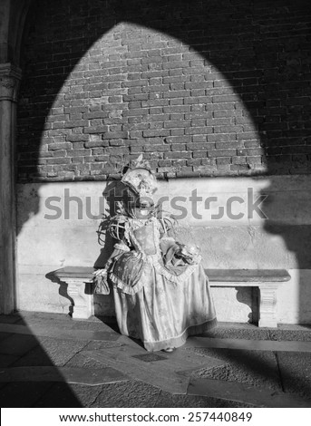 VENICE, ITALY - FEBRUARY 16, 2015: A mask in sunlight near Doge\'s Palace in St Mark\'s Square during traditional Carnival. The Carnival in Venice is annual event which ends on Shrove Tuesday.