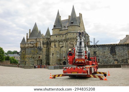 VITRE, FRANCE - JULY 12, 2014: Firemen carry out training exercise near the castle of Vitre. The castle of Vitre was built in 11th century and rebuilt at 13th century.