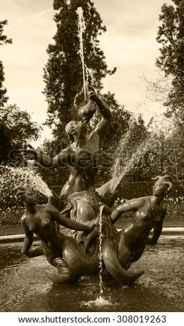 LONDON, ENGLAND, UK - MAY 4, 2014: Triton fountain in the round pool in Queen Mary\'s Garden in Regent\'s park. Queen Mary\'s Gardens were opened to the public in 1932.