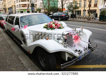 PARIS, FRANCE - JANUARY 4, 2015: Wedding limousine at Parisian street. Paris is one of the most popular destinations for wedding and honeymoon.