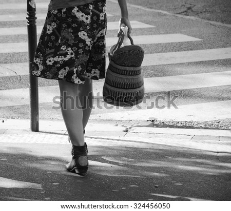 Woman at Parisian street.  Aged photo. Black and white.
