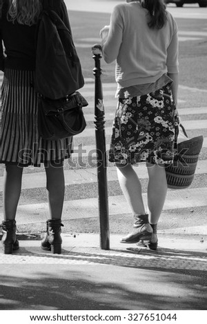 Two women at Parisian street.  Aged photo. Black and white.