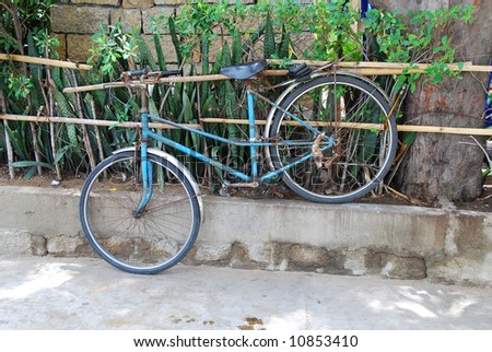 concept of protection: poor bicycle locked to the fence, Vietnam
