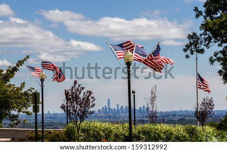 US Flags at the Eagle Rock Reservation in New Jersey with the Skyline of Lower Manhattan and the completed One World Trade Center tower in the background