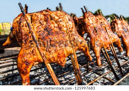 Grilled chicken was spread out with bamboo stick.