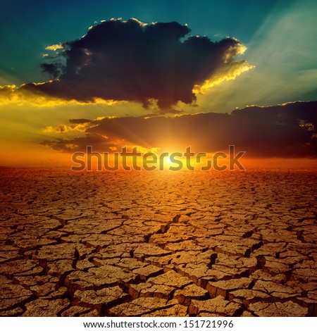 dramatic sunset over drought earth