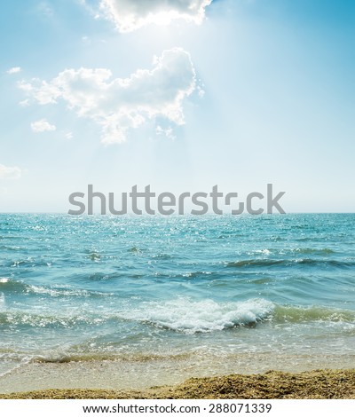 wave on sea and blue sky with clouds and sun
