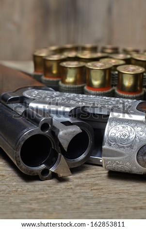 vintage hunting gun with cartridges on wooden background