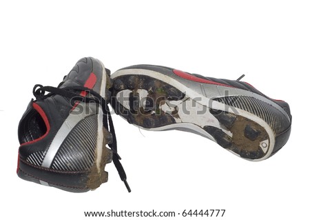 Isolation against white background of muddy soccer cleats