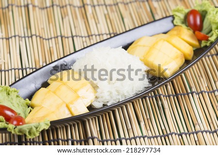 Ripe mango and sticky rice cooked with coconut milk ,Thai dessert