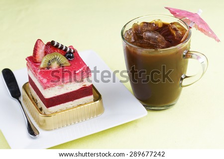 Strawberry Mousse Cake on the white Plate and Ice Coffee