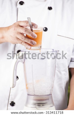 Chef pouring Thai Tea to Blender for make Tea smoothie