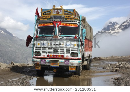 LADAKH, INDIA - CIRCA AUGUST 2011:  Decorated Indian truck negotiates the hazardous Manali-Leh road high in the Himalaya mountains
