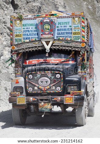 KASHMIR, INDIA - CIRCA  2014: Decorated Indian truck raises dust cloud as it negotiates the hazardous Himalayan Zoji La pass