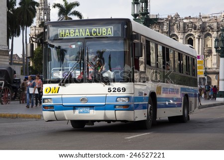 HAVANA, CUBA - CIRCA JANUARY 2014: City bus passing El Capitolio, or National Capitol Building circa January 2014 in Havana