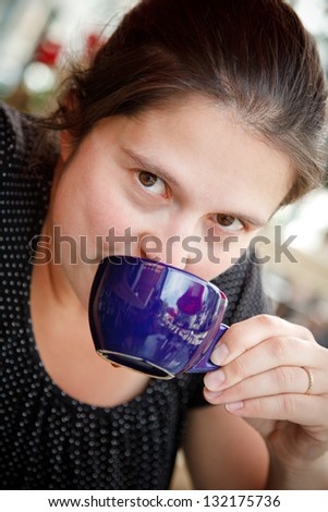 Woman having a coffee outside a restaurant