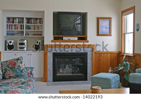 A living room with a fireplace and Television, DVD player
