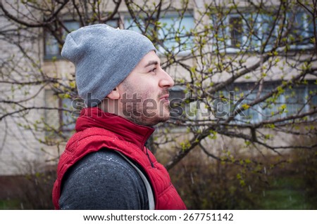 handsome sporty man profile at the street near trees