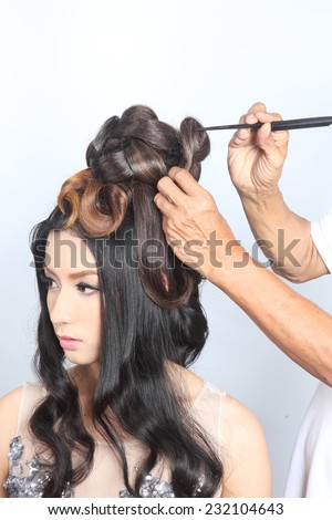 The hairdresser make the hair chignon