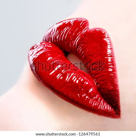 Beautiful female with red shiny lips close up