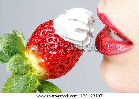 Beautiful red lips and tasty strawberry whipped cream
