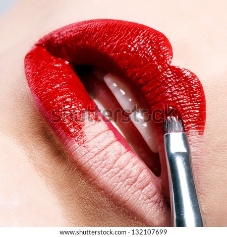 Beautiful shiny red lips as you paint brush