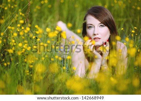 Beautiful woman in flowery meadow