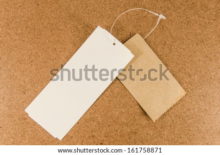 Price tag or address label with string on brown background