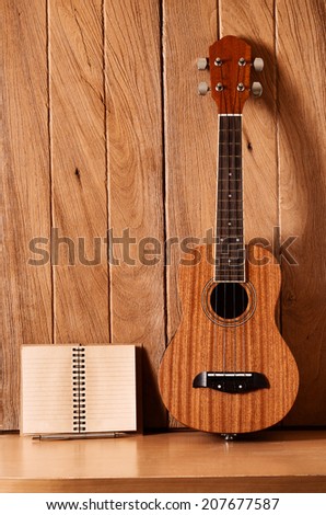 ukulele guitar with notebook