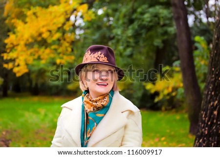 Mature woman wearing retro felt hat and wool coat . Outdoor, Handicraft.