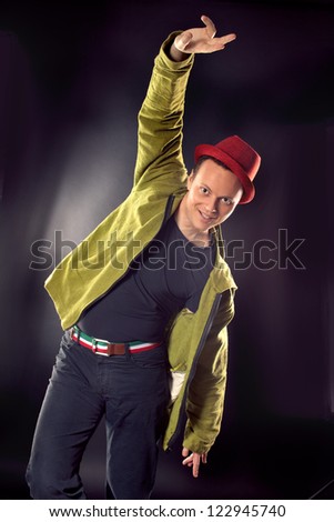 Positive handsome man wearing green jacket , red hat and belt in Italia or Hungarian flag- green, white, red