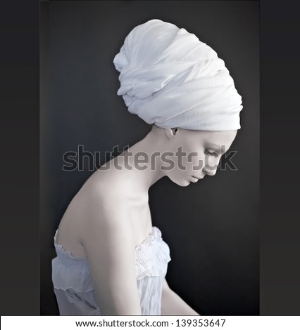 beautiful female model looking as marble statue, wearing head wrap
