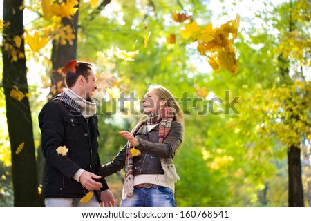 Beautiful blonde woman in autumn park,.cold,flu