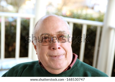 bold handsome elderly man relaxing outdoors