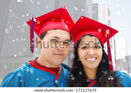 Couple of Hispanic students wearing graduation gowns.
