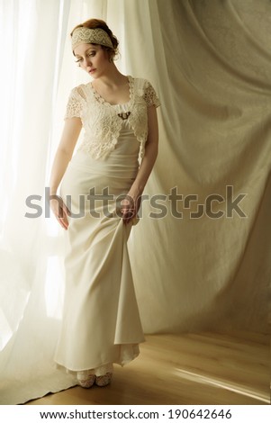 Young red haired curly  girl wearing vintage dress