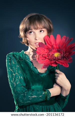 funny girl wearing vintage velvet and lace dress holding huge red flower